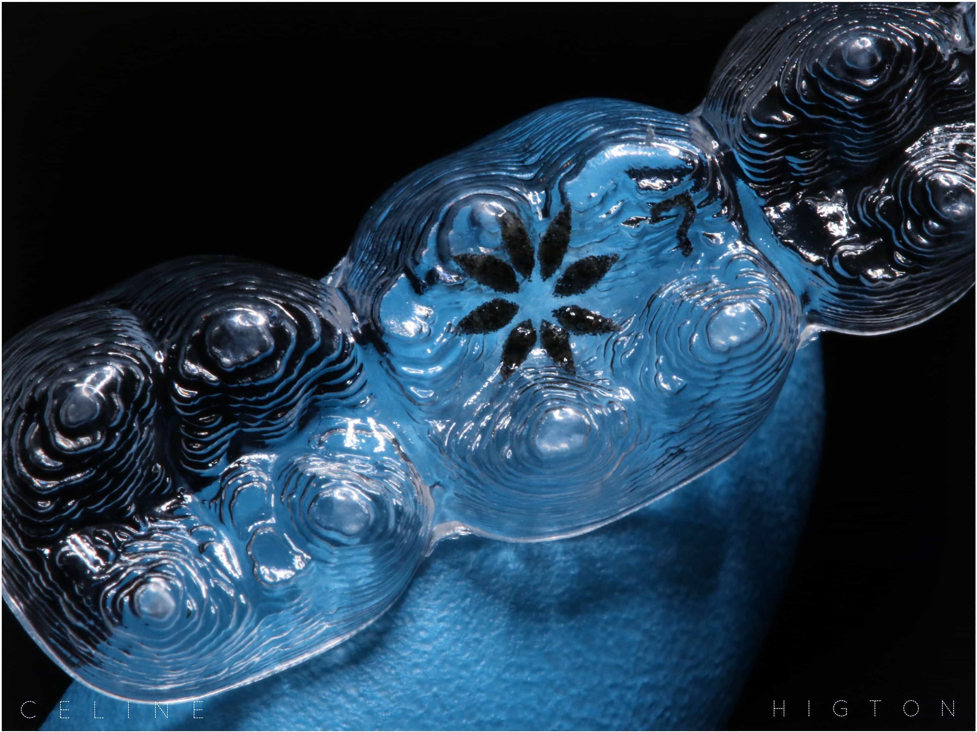 Orthodontics Raynes Park - A Detailed Close-up Image Of An Orthodontic Aligner Featuring A Unique Flower-like Pattern Etched Into The Clear Material. The Aligner, Used For Teeth Straightening, Is Highlighted Against A Dark Background, Showcasing Its Intricate Design And Transparency. Beverley Dental In Raynes Park Offers Advanced Orthodontic Treatments, Including These State-of-the-art Aligners, To Help Patients Achieve A Perfect Smile Discreetly And Comfortably. This Image Emphasizes The Precision And Quality Of The Orthodontic Solutions Provided By Beverley Dental, Reflecting Their Commitment To Modern And Effective Dental Care.